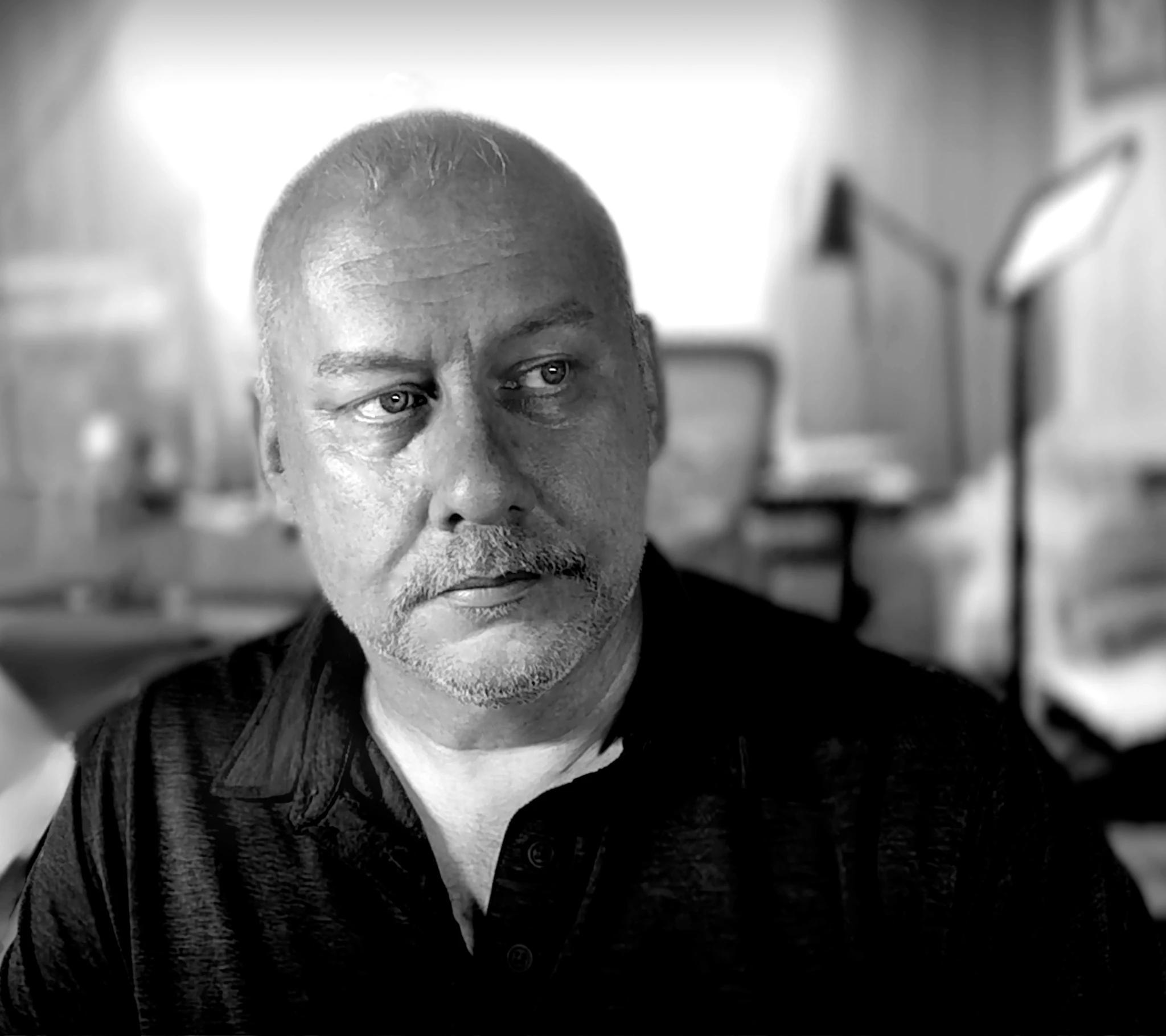 Black-and-white portrait of Heath Poole, facing slightly to the side